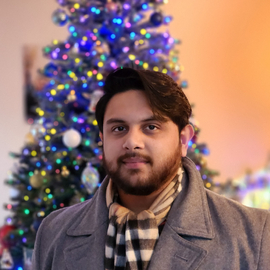 Tristan in front of the tree